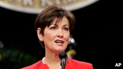 FILE - In this Jan. 16, 2015, photo, Iowa's then-lieutenant governor, Kim Reynolds, delivers remarks after taking the oath of office during inauguration ceremonies in Des Moines.
