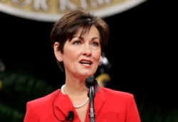 FILE - Iowa Gov. Kim Reynolds said she will fly to Washington this week to update President Donald Trump and Vice President Mike Pence.