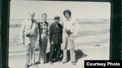 The black and white group photograph shows Richard Dudman (far left), Malcolm Caldwell (far right) and Elizabeth Becker (center left), with Commander Pin (center right), a senior Khmer Rouge military figure, near the eastern border with Vietnam preparing for war. (Courtesy photo of Elizabeth Becker)