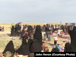 In the final weeks IS held a camp near Baghuz, Syria thousands of people evacuated the area, far more than any militaries or aid groups expected, pictured near Baghuz on March 10, 2019.