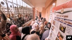 Egyptian voters crowd to cast their votes for the presidential elections at a polling station, in Cairo, Egypt, Sunday, Dec. 10, 2023.