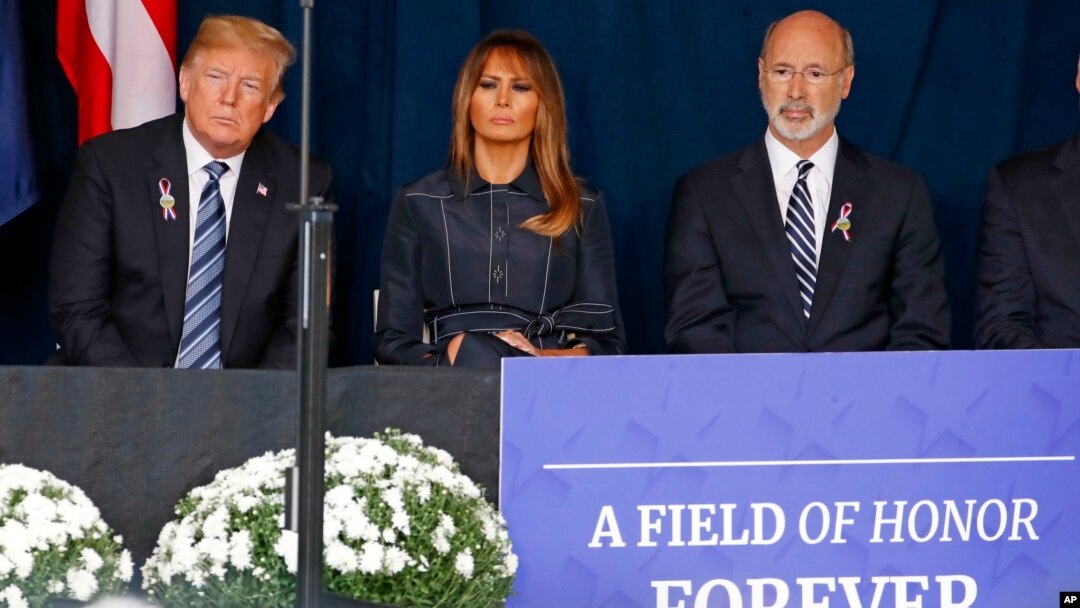 President Donald Trump, left and first lady Melania Trump, center, and Pennsylvania Governor Tom Wolf, listen as the names of the 44 people who died in the crash of Flight 93 are read during the September 11th Flight 93 Memorial Service in Shanksville, Pa