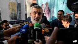 FILE - Revolutionary Guard aerospace division commander Gen. Amir Ali Hajizadeh speaks with media members as he arrives at a ceremony in Tehran, Iran, Nov. 13, 2023,