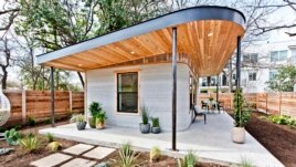 This photo provided by ICON shows one of its 3D-printed homes in Austin, Texas. (Regan Morton Photography/Courtesy of ICON via AP)