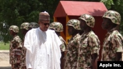 FILE - Nigerian President Muhammadu Buhari reviews troops in Maiduguri, Oct. 1, 2017.