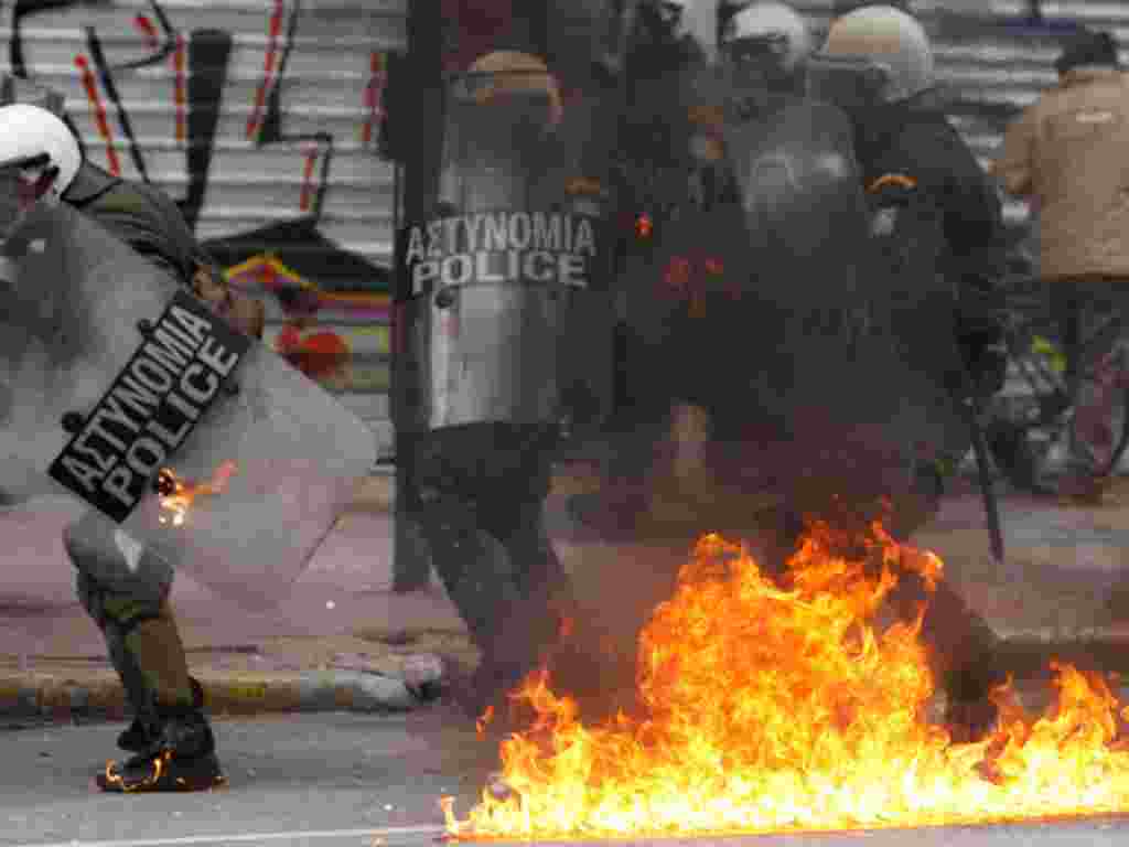 Riot police try to avoid a gasoline bomb during clashes in Athens, February 10, 2012. (AP)