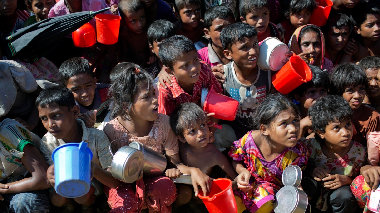 Rohingya Muslim children, who crossed over from Myanmar into Bangladesh, wait squashed against each other to receive food handouts distributed to children and women by a Turkish aid agency at the Thaingkhali refugee camp in Ukhiya, Bangladesh, Nov. 14, 20