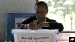 FILE - A woman casts her ballot at a local polling station in Bago, about 90 kilometers northeast of Yangon, Myanmar.