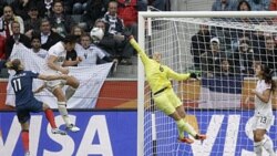 The United States' Abby Wambach, in white shirt, left, scores the second goal for her team in the semifinal. The United States defeated France 3-1.