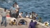 Migrants react as they arrive at the port in La Restinga on the Canary island of El Hierro, Spain, on Aug. 19, 2024. 