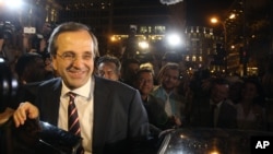 Leader of the New Democracy conservative party Antonis Samaras leaves an elections kiosk after speaking to his supporters at Syntagma square in Athens, Sunday, June 17, 2012.