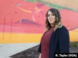 Brandy Corwin, 28, was laid off from General Motors twice before making the switch to become a call center employee at Credit Adjustments, Inc., a decision she says has afforded her stability as a mother of two.