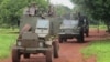 In this June 25, 2014 photo, Ugandan troops patrol the town of Zemio in Central African Republic, where they are hunting down the fugitive members of the Lord's Resistance Army rebel group. (AP Photo/Rodnet Muhumuza)