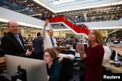 FILE - With Executive Editor Jill Abramson (R), publisher Arthur Sulzberger Jr. holds up four fingers to indicate the four Pulitzer Prizes won by the New York Times, as winners for the 2013 Pulitzer Prize are announced in the newsroom in New York.
