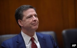 FBI Director James Comey waits for the start of a meeting with Attorney General Jeff Session at the Department of Justice in Washington, Feb. 9, 2017.