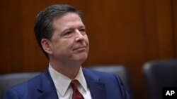 FBI Director James Comey waits for the start of a meeting with Attorney General Jeff Session at the Department of Justice in Washington, Feb. 9, 2017.