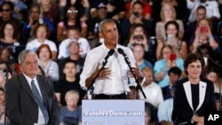 Former President Barack Obama speaks at a rally in support of candidate for Senate Rep. Jacky Rosen, D-Nev., right, and Clark County Commission Chair and Democratic gubernatorial candidate Steve Sisolak, left, in Las Vegas, Oct. 22, 2018.