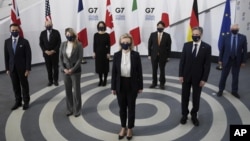 7 foreign ministers, pose in a socially distanced manner for a group photo at the Museum of Liverpool, Liverpool, England, Saturday Dec. 11, 2021. Foreign Secretary Liz Truss is hosting U.S. Secretary of State Antony Blinken and other Group of Seven count