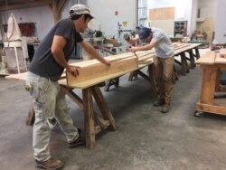 Students work on a woodworking project in a Timber Framing class at the American College of the Building Arts, Charleston, S.C., Sept. 17, 2019. (J. Taboh/VOA News)
