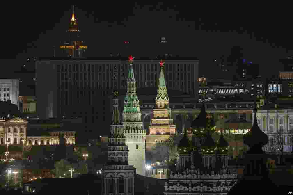 The Kremlin's Towers and a church are illuminated before the lights were turned off to mark Earth Hour in Moscow, Russia, March 25, 2017. Earth Hour is marked around the world, with millions expected turn out the lights to raise awareness about climate ch