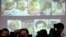 FILE - Surrogate babies that Thai police suspect were fathered by a Japanese businessman who has fled from Thailand are shown on a screen during a news conference at the headquarters of the Royal Thai Police in Bangkok.