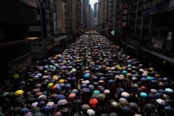 Protesters carrying umbrellas take part in march in Hong Kong, Sept. 15, 2019.