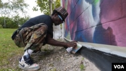 Eric Ricks paints a mural in Washington, D.C.