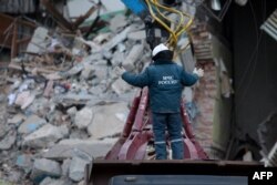 An emergency worker takes part in a search operation two days after a gas explosion rocked a residential building in Magnitogorsk, Russia, Jan. 2, 2019.