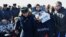 Ground personnel carry the International Space Station (ISS) crew member Russian actor Yulia Peresild after landing in a remote area outside Zhezkazgan, Kazakhstan, Oct. 17, 2021.