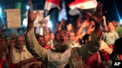  A supporter of Egypt's ousted President Mohammed Morsi chants slogans during a protest outside Rabaah al-Adawiya mosque, where protesters have installed a camp and hold daily rallies at Nasr City in Cairo, Egypt, Aug. 4, 2013.