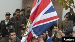 Protesters remove the flag of the British embassy in Tehran, November 29, 2011.