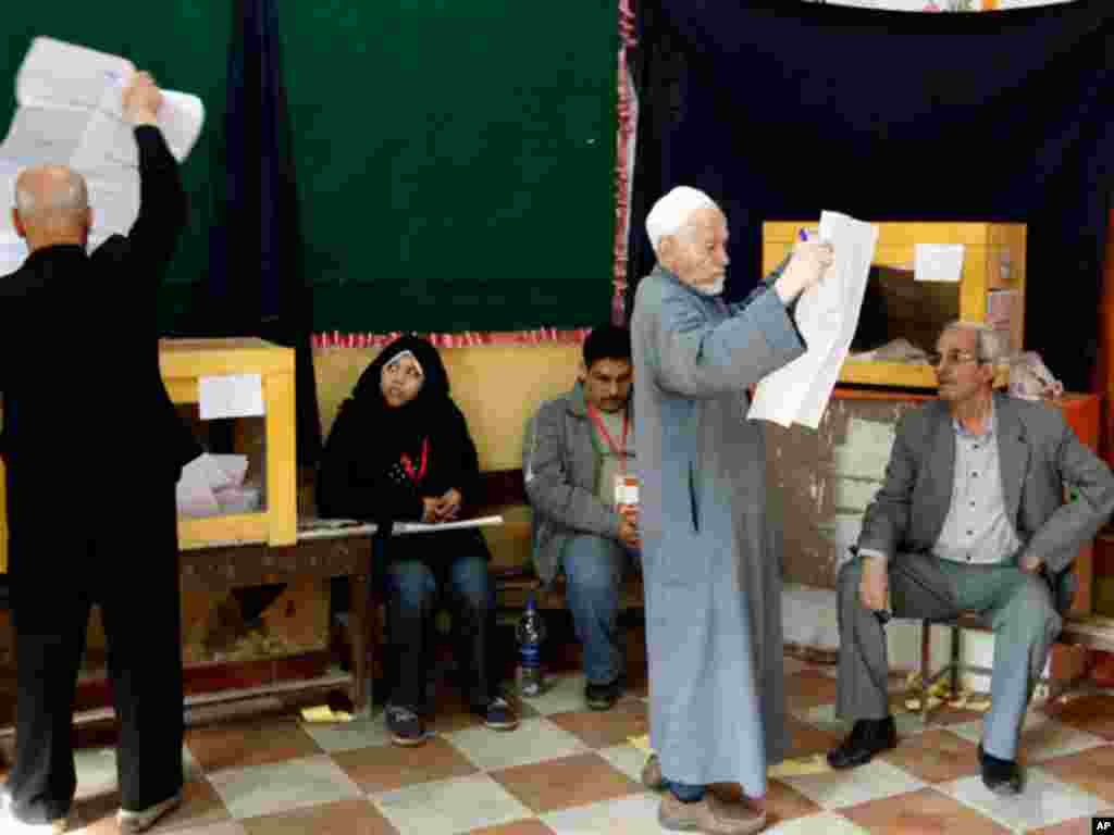 A man looks at a list of candidates before voting in Cairo. (Reuters)