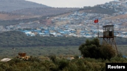 A Turkish military armored vehicle patrols on the border line located opposite the Syrian town of Atimah, Idlib province, in this picture taken from Reyhanli, Hatay province, Turkey Oct. 10, 2017.