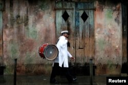 A musician walks in the French Quarter as Hurricane Nate approaches the U.S. Gulf Coast in New Orleans, Oct. 7, 2017.