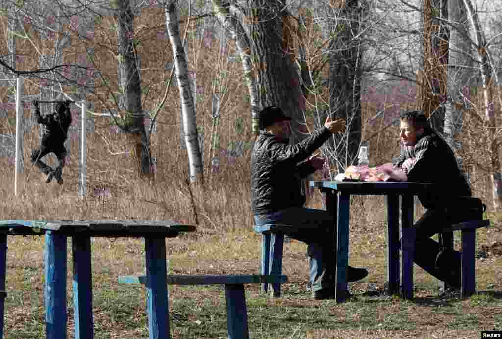 Men talk as they share a meal in the village of Novi Sanzhary, where the evacuees from coronavirus-hit China&#39;s Hubei province are quarantined at a sanatorium, in Poltava region, Ukraine.