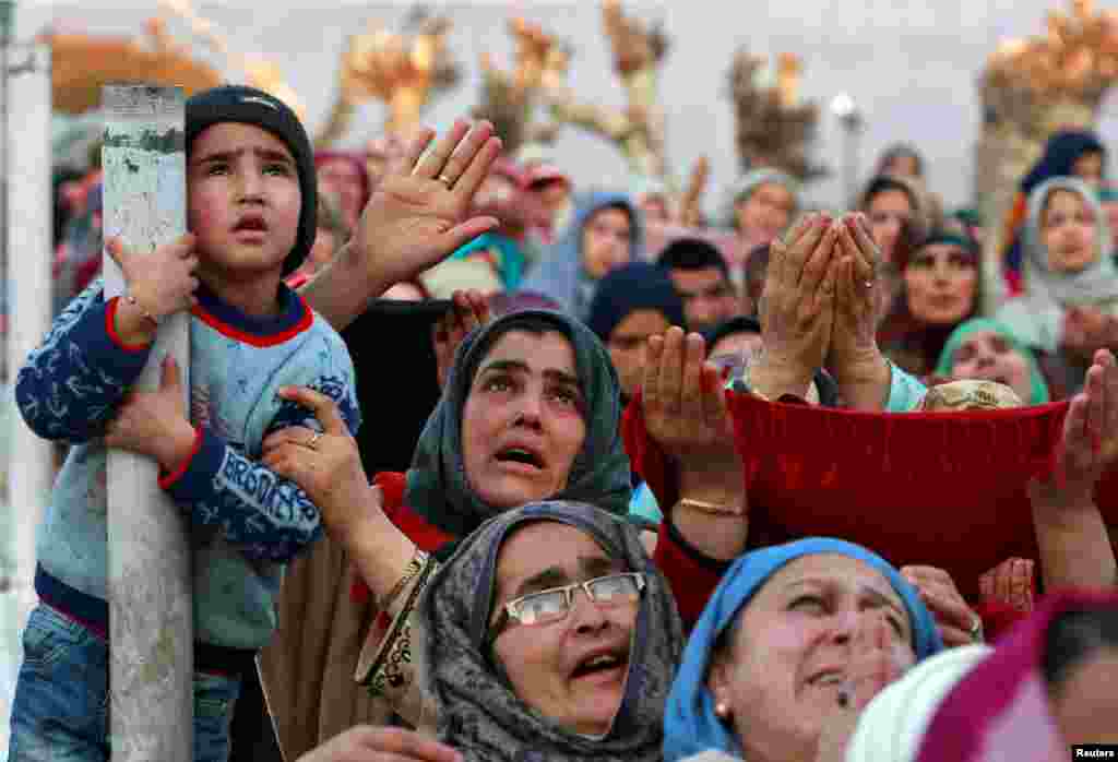 Kashmiri Muslims react upon seeing a relic believed to be hair from the beard of Prophet Mohammed, during a festival to mark the death anniversary of Abu Bakr, one of the companions of Prophet Mohammad, at the Hazratbal shrine in Srinagar, India.