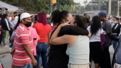 Women hug while waiting for some information about their relatives who are inmates at Litoral Penitentiary, after a prison riot, in Guayaquil, Ecuador, Wednesday, September 29, 2021. (AP Photo/Angel DeJesus)