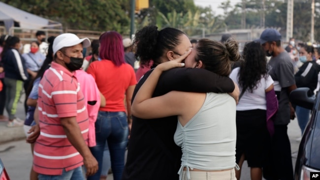 Women hug while waiting for some information about their relatives who are inmates at Litoral Penitentiary, after a prison riot, in Guayaquil, Ecuador, Wednesday, September 29, 2021. (AP Photo/Angel DeJesus)