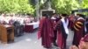 FILE - Billionaire investor Robert Smith, second from left, is seen after pledging to pay off the student loan debt of the entire Class of 2019 at Morehouse College in Atlanta, May 19, 2019, in this picture obtained from social media. (D. Moody/Reuters)