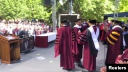 FILE - Billionaire investor Robert Smith, second from left, is seen after pledging to pay off the student loan debt of the entire Class of 2019 at Morehouse College in Atlanta, May 19, 2019, in this picture obtained from social media. (D. Moody/Reuters)