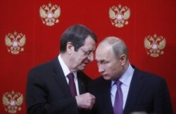 FILE - Russian President Vladimir Putin, right, and Cypriot President Nicos Anastasiades speak at the Kremlin in Moscow, Russia, Oct. 24, 2017.
