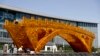 Workers install wires on a Golden Bridge of Silk Road structure on a platform outside the National Convention Center, the venue which will hold the Belt and Road Forum for International Cooperation, in Beijing, April 18, 2017.