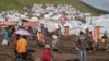 FILE — People displaced by the ongoing fighting between the Democratic Republic of Congo's military and M23 rebels gather in a camp on the outskirts of Goma, on March 13, 2024,