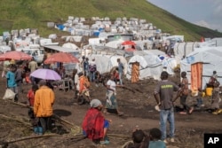 People displaced by the ongoing fighting between Congolese forces and M23 rebels gather in a camp on the outskirts of Goma, Democratic Republic of Congo, Wednesday, March 13, 2024. (Moses Sawasawa/AP)