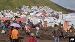 FILE—People displaced by the ongoing fighting between Congolese forces and M23 rebels gather in a camp on the outskirts of Goma, Democratic Republic of Congo, March 13, 2024,