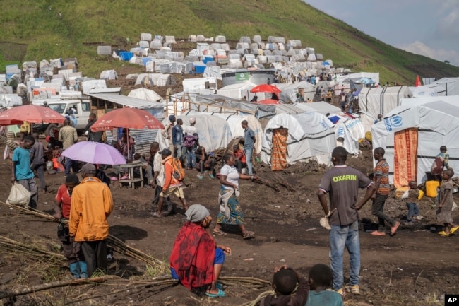 People displaced by the ongoing fighting between Congolese forces and M23 rebels gather in a camp on the outskirts of Goma, Democratic Republic of Congo, Wednesday, March 13, 2024. (Moses Sawasawa/AP)