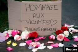 A placard reads "Tribute to the victims. I am Strasbourg", in Strasbourg, eastern France, Dec. 12, 2018.