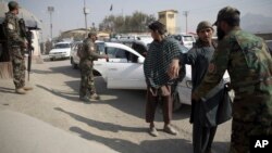 FILE - Afghan National Security Forces search passengers and vehicles at a checkpoint in Kabul, Afghanistan, Oct. 26, 2018.