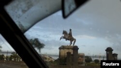 FILE - A statue of King Menelik II, the founder of Addis Ababa, is seen through the window of a taxi, in the capital Addis Ababa, Ethiopia, May 17, 2015. The Menelik palace opened to the public this month after being closed for more than a century.