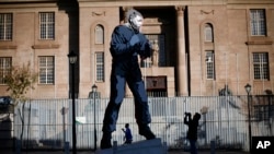 A giant statue of former South African President Nelson Mandela stands outside the Magistrate’s Court, in Johannesburg, South Africa, June 18, 2013.